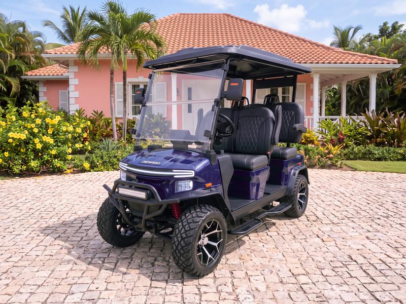Denago Rover XL four-seat electric golf cart in navy blue on a cobblestone driveway in front of a coral pink Caribbean villa with white shutters in Casa de Campo