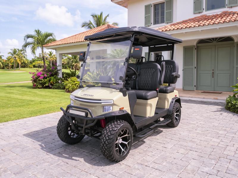 Denago Rover XL four-seat electric golf cart in khaki on a grey stone driveway in front of a white villa with sage green shutters beside the golf course in Casa de Campo