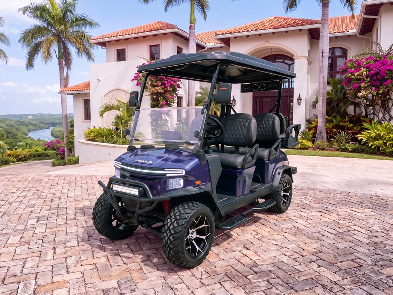 Denago Rover XL6 six-seat electric golf cart in navy blue on a stone driveway in front of a hillside villa above the Chavón River in Casa de Campo