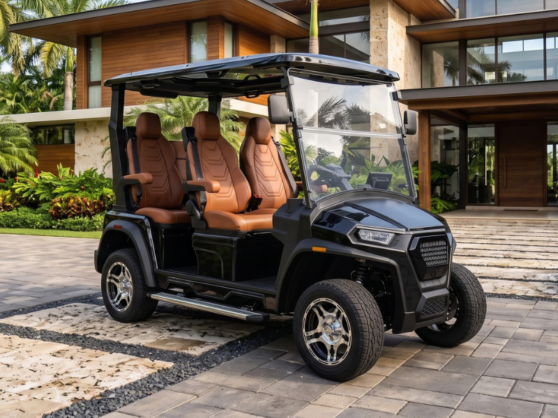 ECO Azure 4 2WD electric golf cart in black with brown seats parked in front of a modern villa