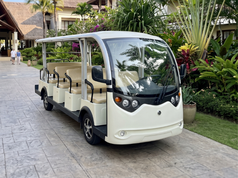 ECO E-Bus S14 fourteen-seat electric shuttle bus on a resort driveway